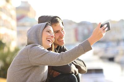 A couple taking a photo after having Dental Veneers at Sparkling Dental