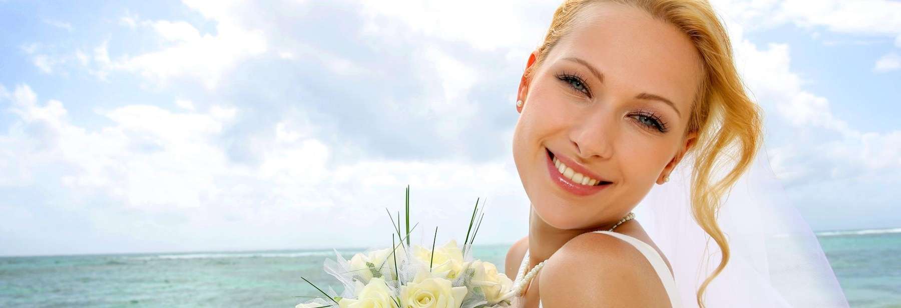 A blonde woman smiling after a teeth whitening treatment in Neutral Bay