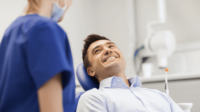 Man smiling during dental check up ad examination at Sparkling Dental