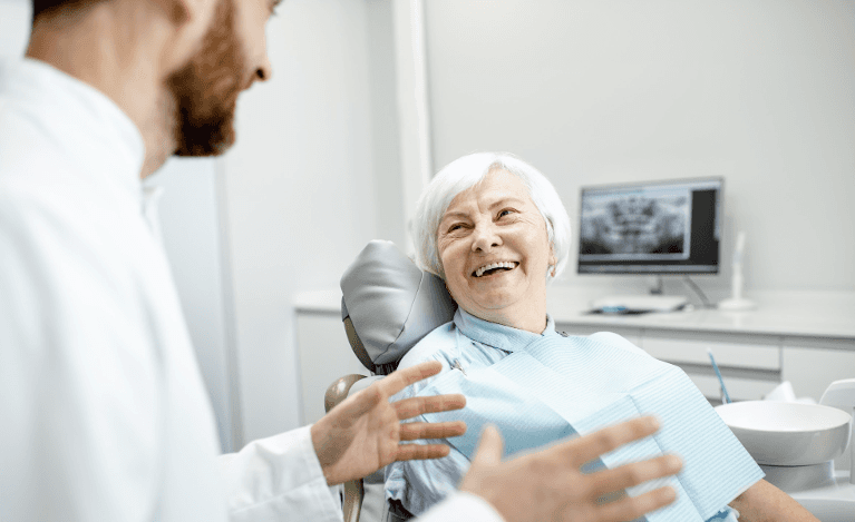 A picture of a dentist explaining root canal therapy to an elderly lady in Neutral bay, NSW.