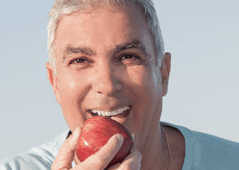 Man eating an apple in Neutral Bay, NSW