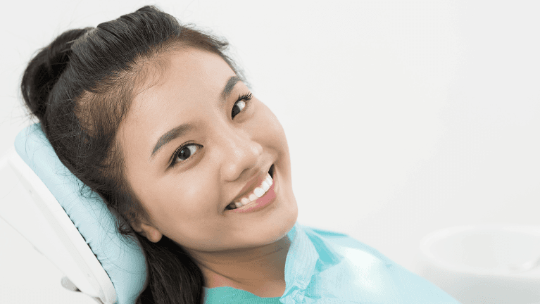 Lady smiling after root canal treatment at Sparkling Dental