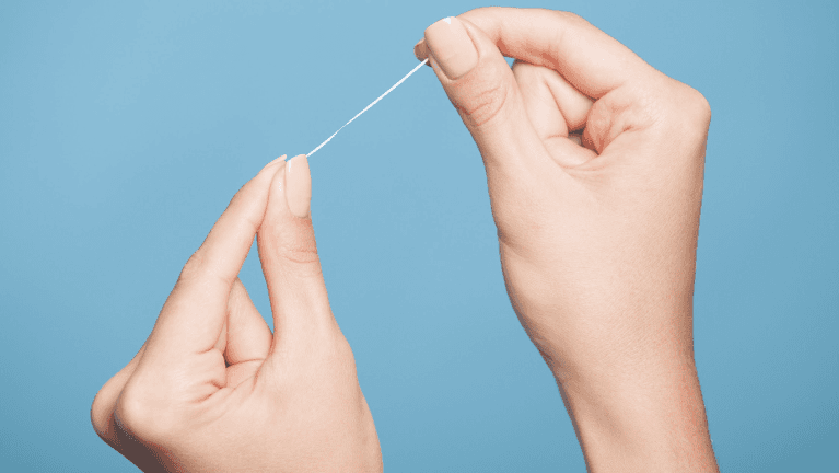 Photo of hands holding a dental floss in Neutral Bay, NSW