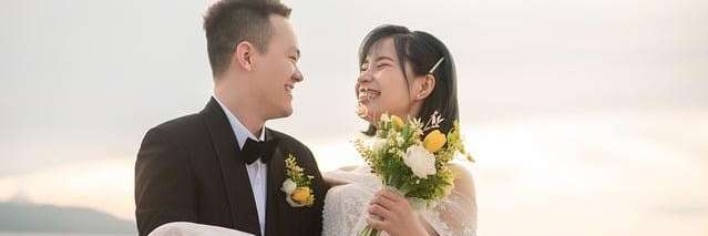 A smiling couple holding flowers in Neutral Bay, NSW.