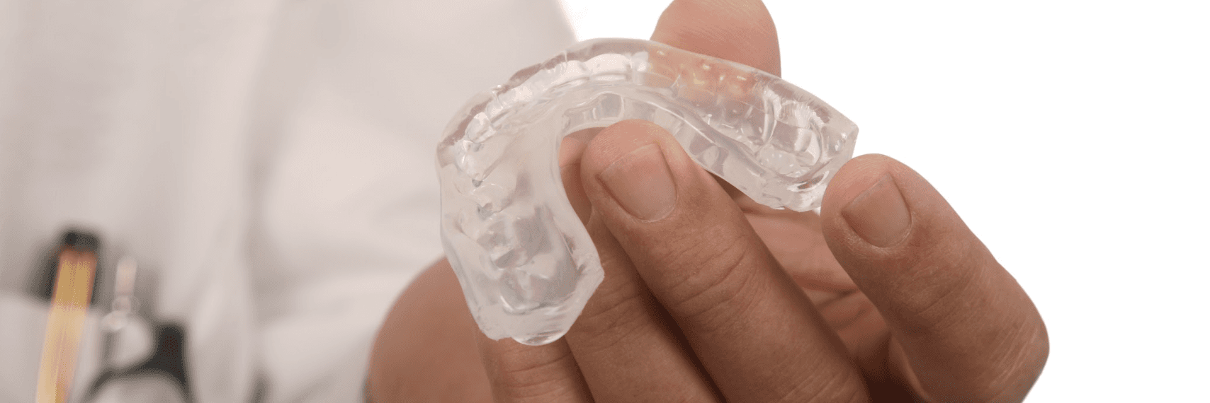Hand holding Invisalign clear braces in Neutral Bay, NSW