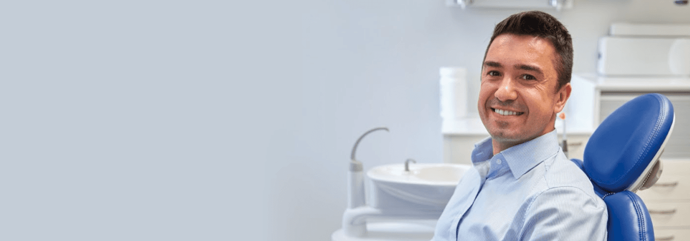 Man relaxing on dental chair after flossing his teeth at Sparkling Dental