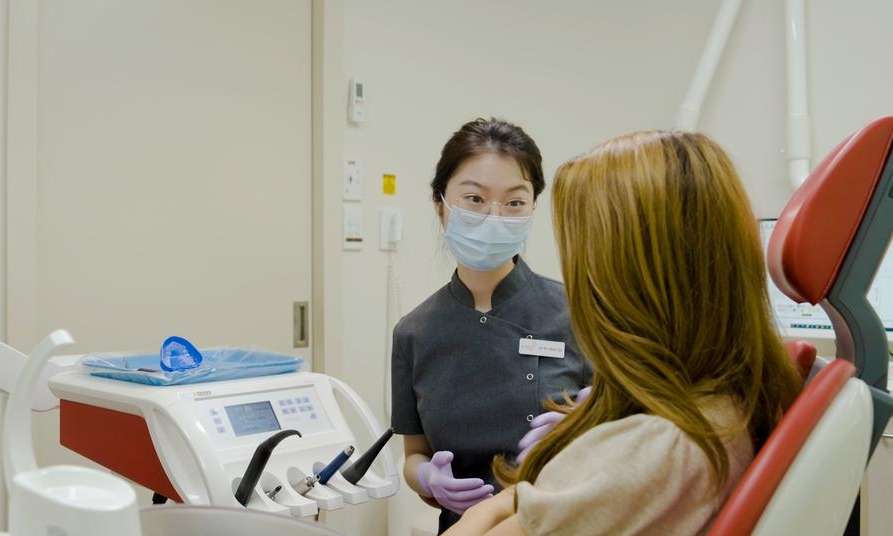 Dentist examining a patient at Sparkling Dental